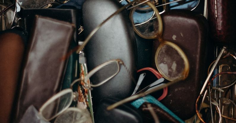 Swaps - Black and Brown Leather Bifold Wallet Beside Black Framed Eyeglasses