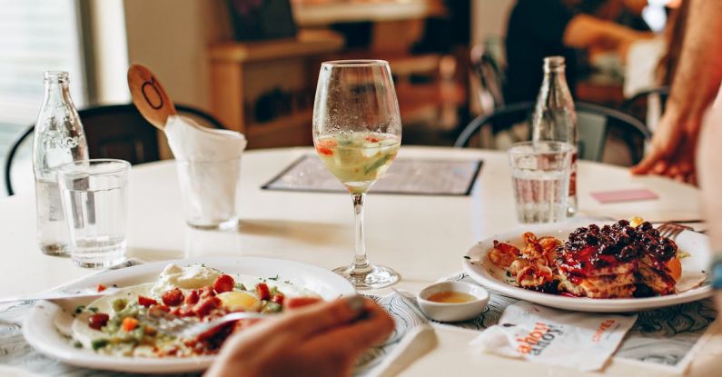 Eating Out - Wine in Clear Glass Near Food on Plate on Table