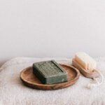 Personal Care Products - Natural toiletries and towels on stool