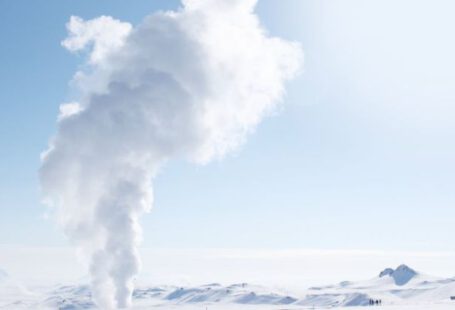Geothermal Energy - Smoke Rising from Snow-covered Field